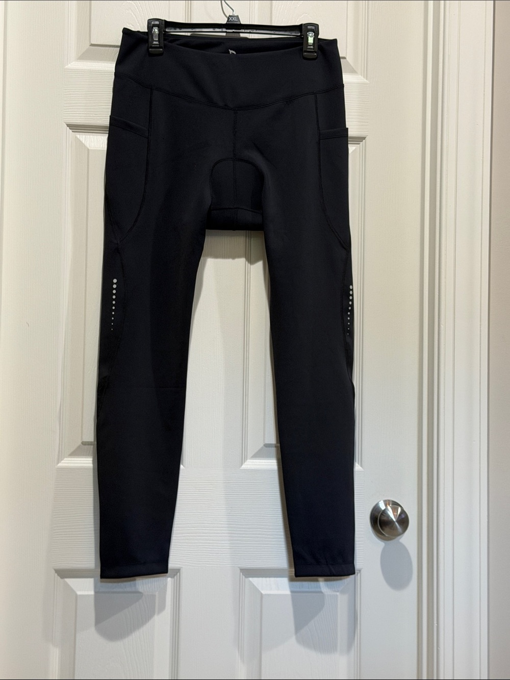 Baleaf Black Women's High-Waist Leggings with Side Pockets and Reflective Dots.